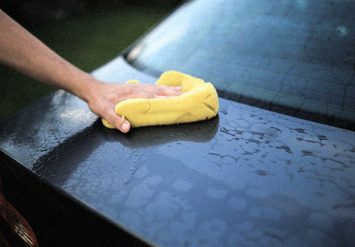A man cleaning the car