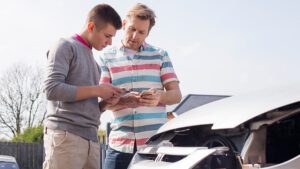 two persons checking their phones for help